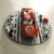 Escultura "Só o Fiapo!" em base de MDF, com resto de carrinho Hot Wheels e sobras diversas. Itens reciclados. 9 X 2 cm. - Raridades Curitiba