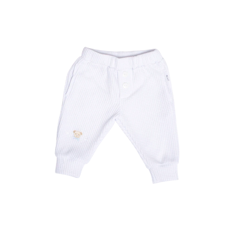 Pantalón blanco para bebés con bordado de osito en la parte delantera.