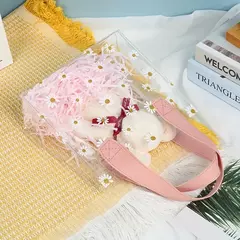 Bolsa pvc cristal con margaritas y manija de cuerina rosa. Precio x unidad.