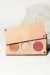 Paleta de maquillaje "paletita rosa frost" con tres tonos: bronceador, iluminador y rubor, sobre fondo blanco.