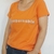 Remera Ingobernable Escote Redondo Naranja Glither en internet