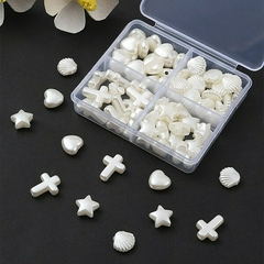 Imagen de KIT CUENTAS NACARADAS 4 FORMAS CORAZON ESTRELLA CRUZ OSTRA X 35G X 85 UNI
