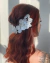 Arranjo de cabelo floral delicado adiciona um toque romântico ao seu visual de noiva.