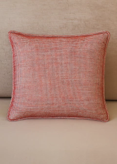 Almofada retangular em chenille vermelho com detalhe em vivo, sobre sofá bege