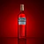Garrafa de Campari iluminada sobre fundo vermelho escuro