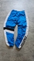 Pantalón rompevientos de color azul con detalles en blanco y negro de la marca Starter.