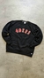 Buzo negro de la NFL con estampado de "49ERS" en letras rojas.