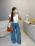 Blusa canelada com decote diagonal - off white na internet