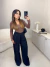 Calça alfaiataria wide leg com fechamento frontal de botão - preto - comprar online