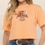 Camisa cropped feminina laranja com estampa de cavalos e a palavra "MEXICO".