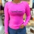 Camiseta UV50+ térmica feminina rosa da marca Texas Farm, com logo em destaque na frente.