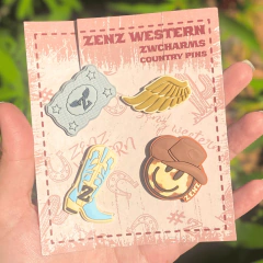 Kit com 4 pins metálicos Zenz para Crocs, com designs country como chapéu, bota, asa dourada e distintivo, em embalagem temática segurada por uma mão.