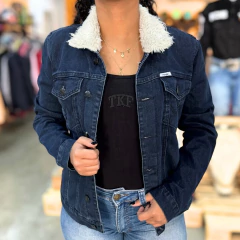 Jaqueta jeans feminina Wrangler azul escuro com gola de pelúcia branca, usada por mulher com camiseta preta e calça jeans clara
