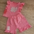 conjunto 2 piezas con short y remera  con volados en color fucsia
