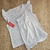 Conjunto para niñas compuesto por una camiseta de manga corta con volados y un short, ambos con un estampado sutil de cebra en tonos claros.