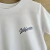 REMERA CALIFORNIA CREW - NATURAL