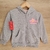 Campera gris para bebés con capucha estampada