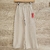 Pantalón de algodon de niña de color beige, con cintura elástica y detalles de costura blanca