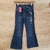 Pantalón de jean para niñas con estampado floral en el lateral, color azul oscuro.