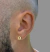 PAR DE BRINCOS REDONDO COM CRUZ CRAVEJADA - 7mm - 18k - comprar online