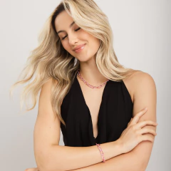 Mulher loira usando vestido preto com colar e pulseira Pop Chain rosa da Jack Vartanian