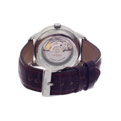 Relógio automático H. Stern com fundo transparente, mostrando o mecanismo interno e a pulseira de couro marrom.