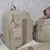 Kit Bolsas Maternidade (Bolsa Grande e Mochila Tradicional e Saquinhos Organizadores Bege com Rosê - comprar online