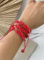 Pulseira macramê strass vermelha na internet