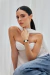 Woman wearing a Mini Belle Murray Gold 24mm watch with a black leather strap.