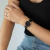 Women's black watch with leather strap, Murray Black Hill 32mm, worn on wrist.