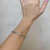 Bracelete Torcido Cabo de Aço Banhado No Ouro/Ródio - PL1292 - comprar online