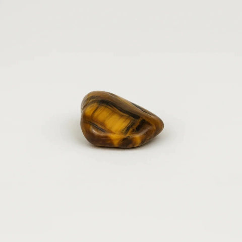 Pedra Olho de Tigre Rolada de bolso - Coragem, Prosperidade e Proteção - comprar online