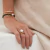 Pulseira com Amarração em Pedras Malaquita, Pérola barroca e Bolinhas em Ouro 18k