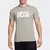 Camiseta Nike Dri Fit IFKYK 1 em tom cinza, com estampa 'Swoosh' e personagem ao lado.