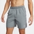 Shorts Nike Challenger cinza, com cintura elástica e logo da Nike na perna.