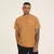 Camiseta New Balance 550 bordada em tom caramelo, com estampa de tênis e logo na parte frontal.