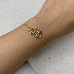 PULSEIRA 2 CORAÇÕES DESENHADO VAZADO PONTO ZIRCÔNIA DOURADO na internet