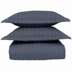 Cobre leito casal matelado em percal 100% algodão na cor cobalto, composto por três peças, incluindo dois travesseiros e uma manta.
