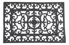 Alfombra de goma negra con diseño ornamental en relieve.