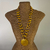 Colar em Tons de Amarelo com Medalhão de Madre Pérola – Biojoia Artesanal Vibrante - comprar online