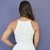 Vista traseira de mulher usando vestido midi branco Jessica Jardim com alças finas e detalhe de zíper nas costas