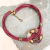 collar artesanal de mujer con dije de vidrio y cordones de cuero color bordo