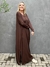 vestido longo, bem amplo, na cor marrom, tem um estilo despojado e moderno