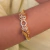 Bracelete dourado de luxo com tigres em 3D e zircônias banhado a ouro 18k