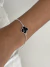 Pulseira trevo preto banhado a prata