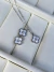 Conjunto trevo branco com pedrinha aço inox