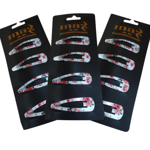 Pack de cuatro hebillas de pelo Tic Tac medianas con estampado floral sobre fondo negro.