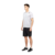 Hombre usando un short de entrenamiento adidas 4krft 360 Elite, con camiseta blanca y zapatillas negras.