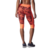 Calza Adidas Capri Sn Gtigat W para mujer, vista trasera con diseño colorido en tonos naranja y negro.