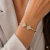 Bracelete Aro Aberto Trevo Cravejado nas Pontas ( Folheado a Ouro 18K e Ródio )